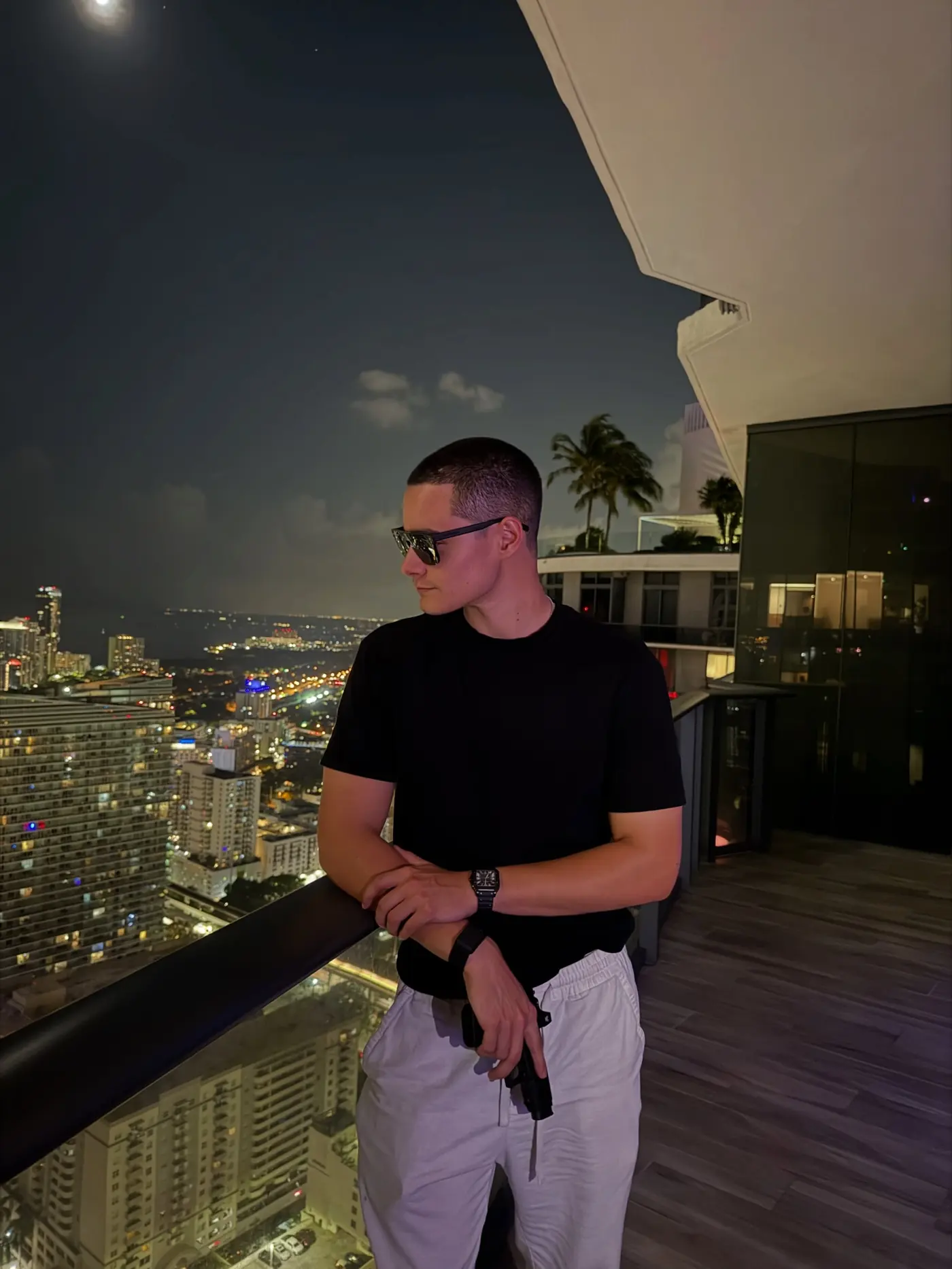 Zander on a high-rise balcony overlooking the city at night