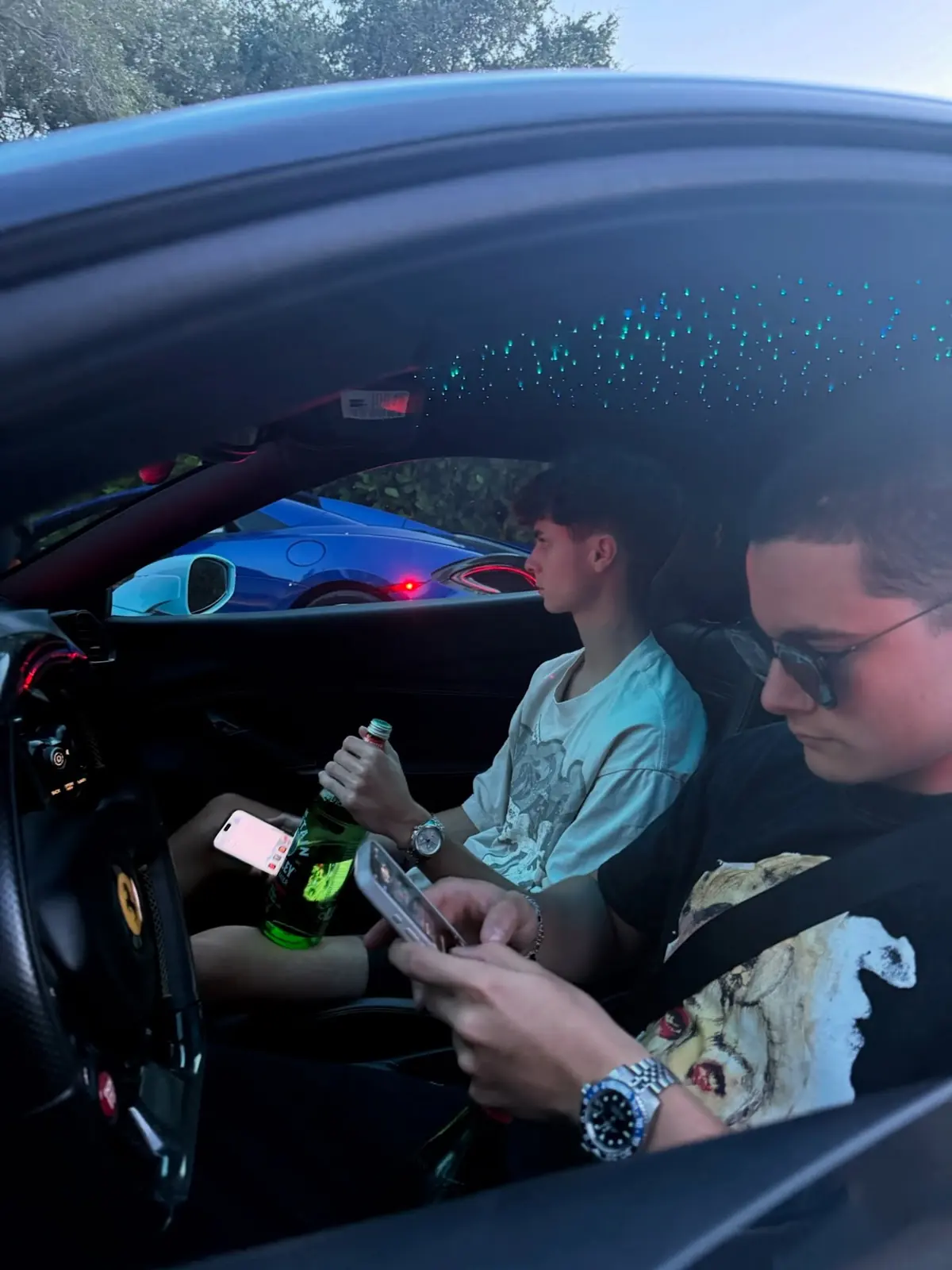 Two passengers in a car at night under a starlight headliner
