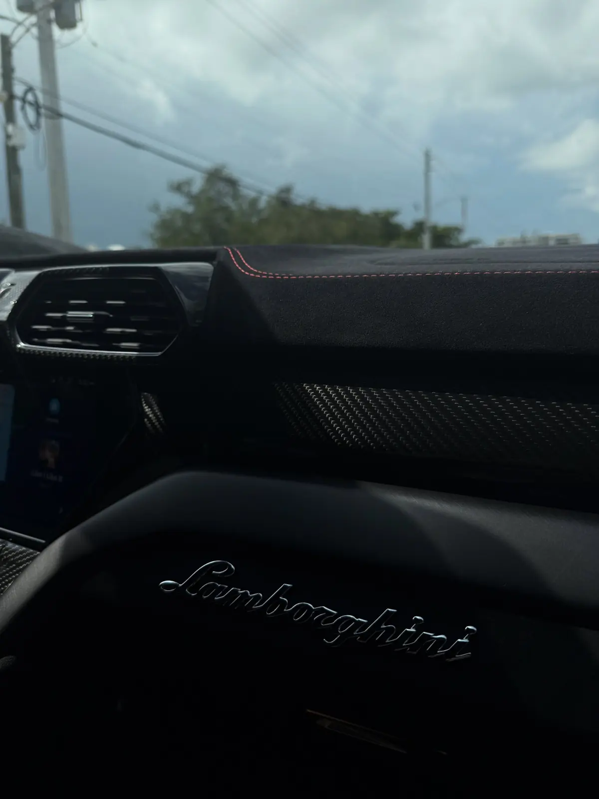 Close-up of a Lamborghini dashboard at dusk