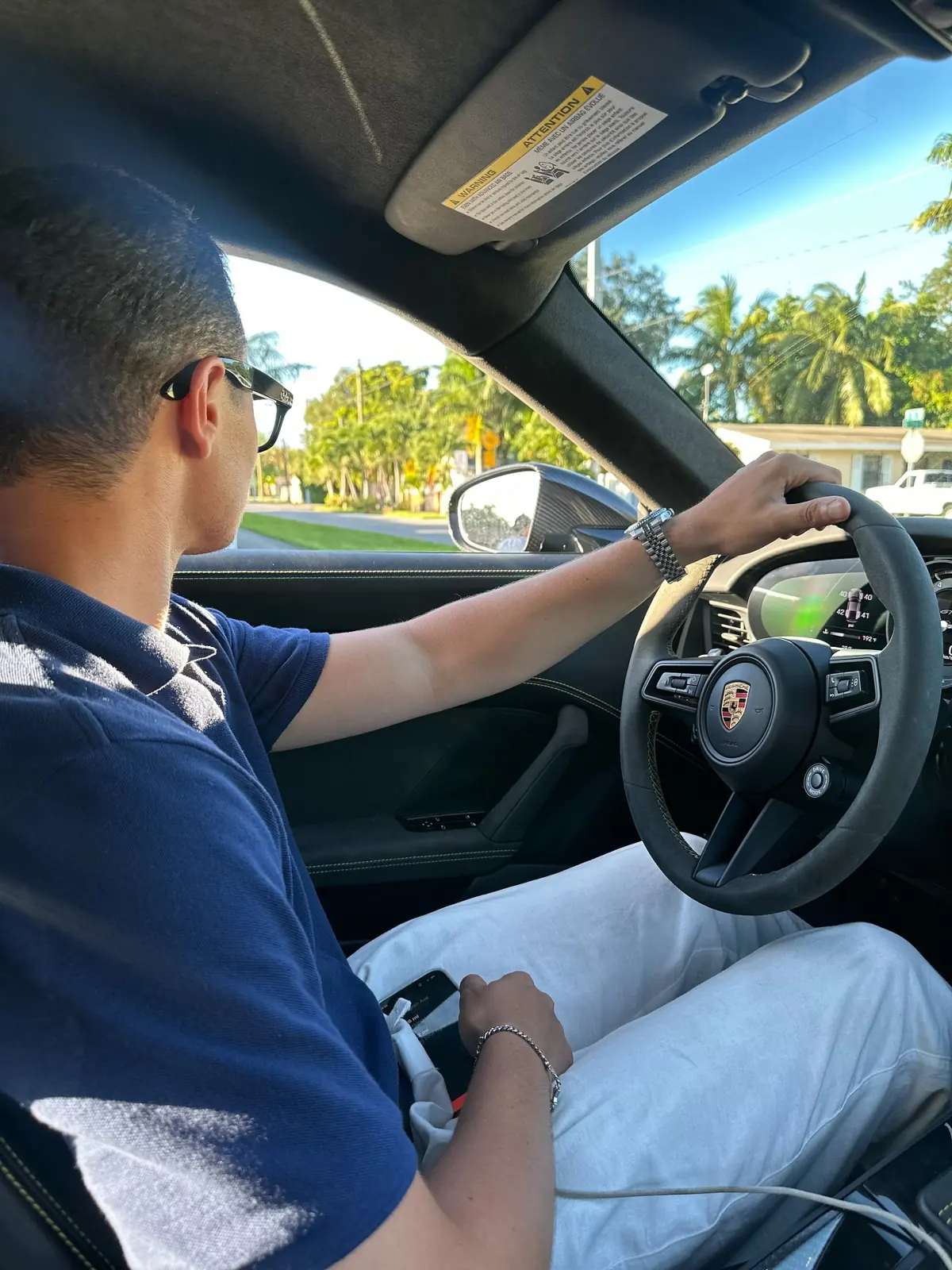 Zander driving, one hand on the wheel