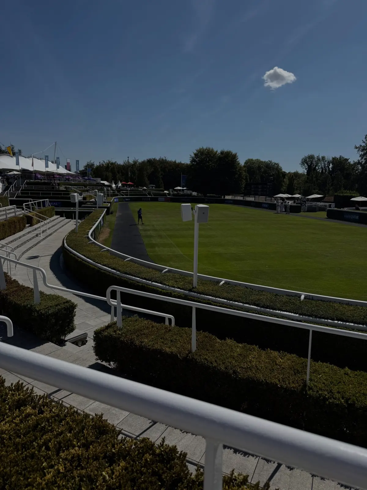 View over a racecourse from a terrace on a clear day